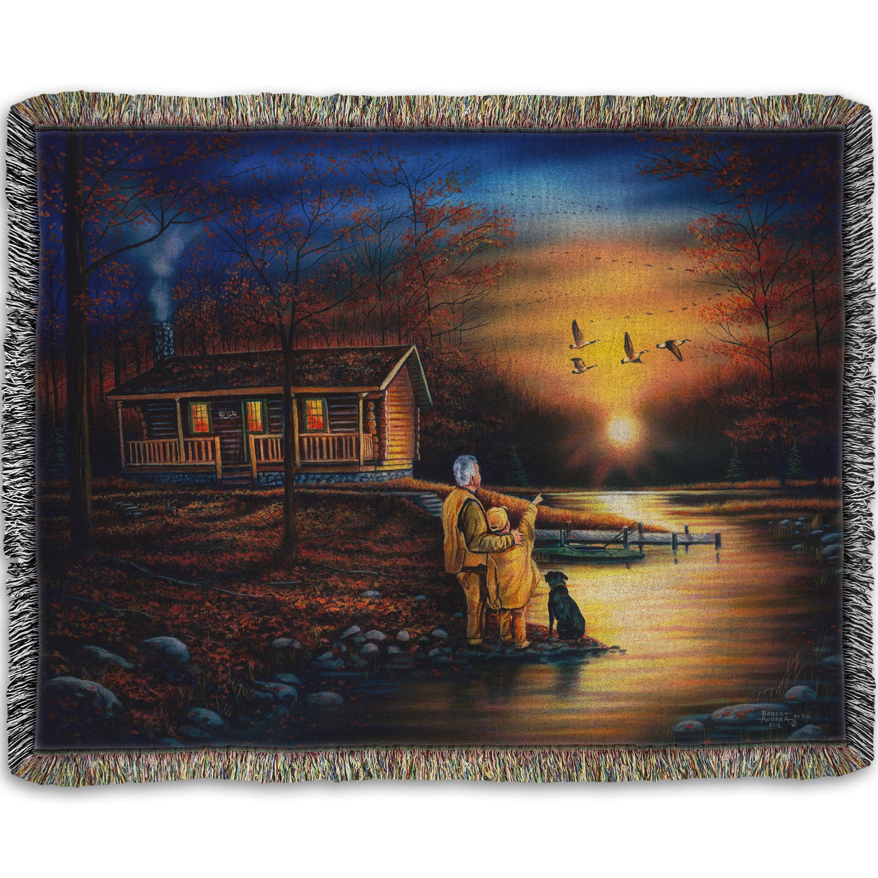 A woven throw blanket designed with a painting of a man and a child standing by a river and cabin. They are watching geese fly overhead at sunset.