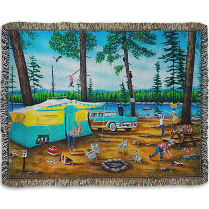 A woven throw blanket designed with a painting of a family camping trip gone awry. The campsite is bombarded by bears, raccoons, and skunks while the children dangle from trees, play in poison ivy, and chase the wild animals.