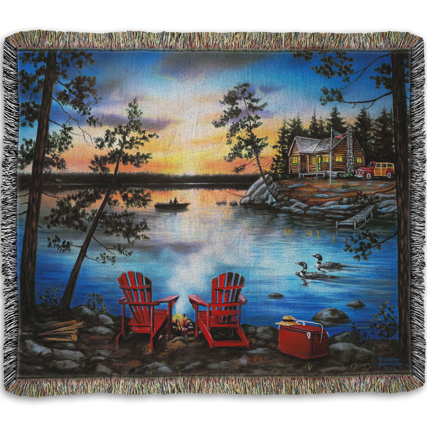 A woven throw blanket designed after a painting of a lake at sunset, with a campfire in the foreground. Two loons drift across the water, as well as two fishers.