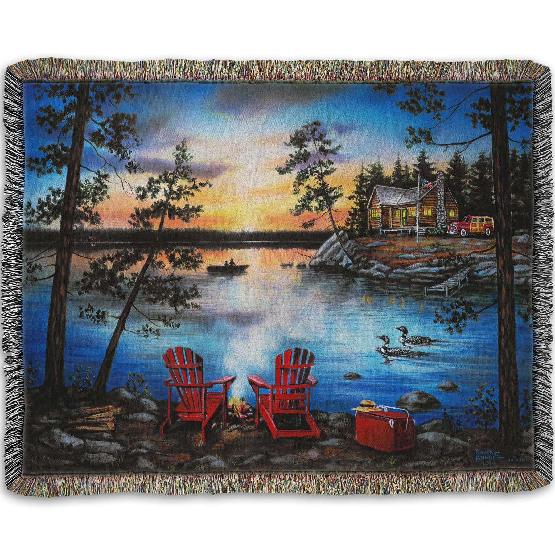 A woven throw blanket designed after a painting of a lake at sunset, with a campfire in the foreground. Two loons drift across the water, as well as two fishers.