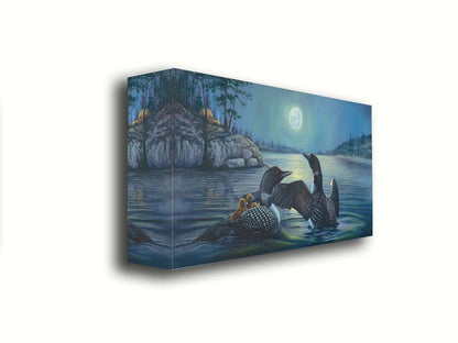 A painting of two grown loons, with two baby loons on one of their backs. They are floating on a lake under the moonlight, with a campground on the land in the distance. Printed on canvas.