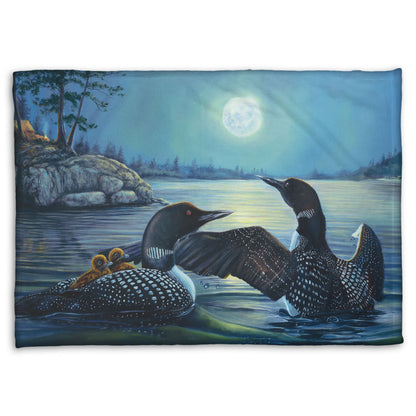 A coral fleece blanket designed with a painting of two grown loons, with two baby loons on one of their backs. They are floating on a lake under the moonlight.