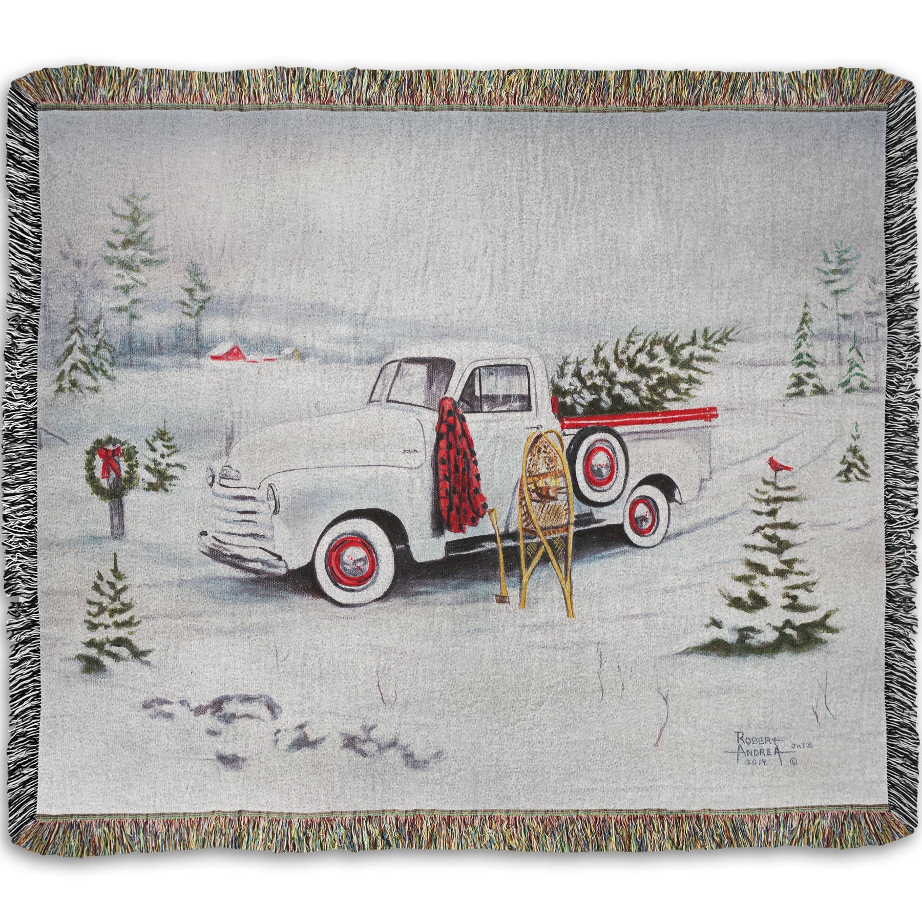 Woven blanket with a truck and Christmas tree design.