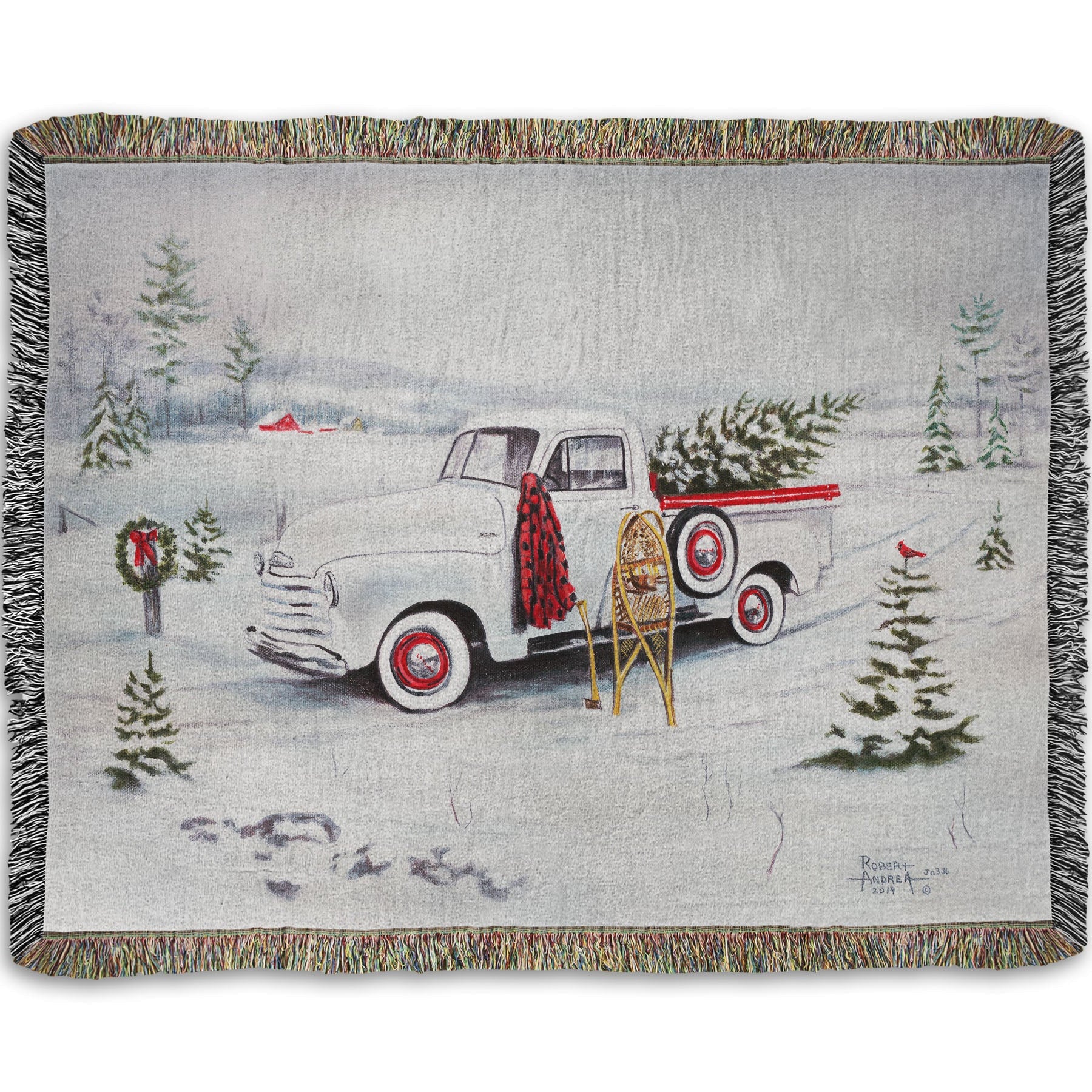 Woven blanket with a truck and Christmas tree design.