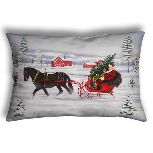 Festive pillow with a horse pulling a family in a sleigh through the snow with a christmas tree.