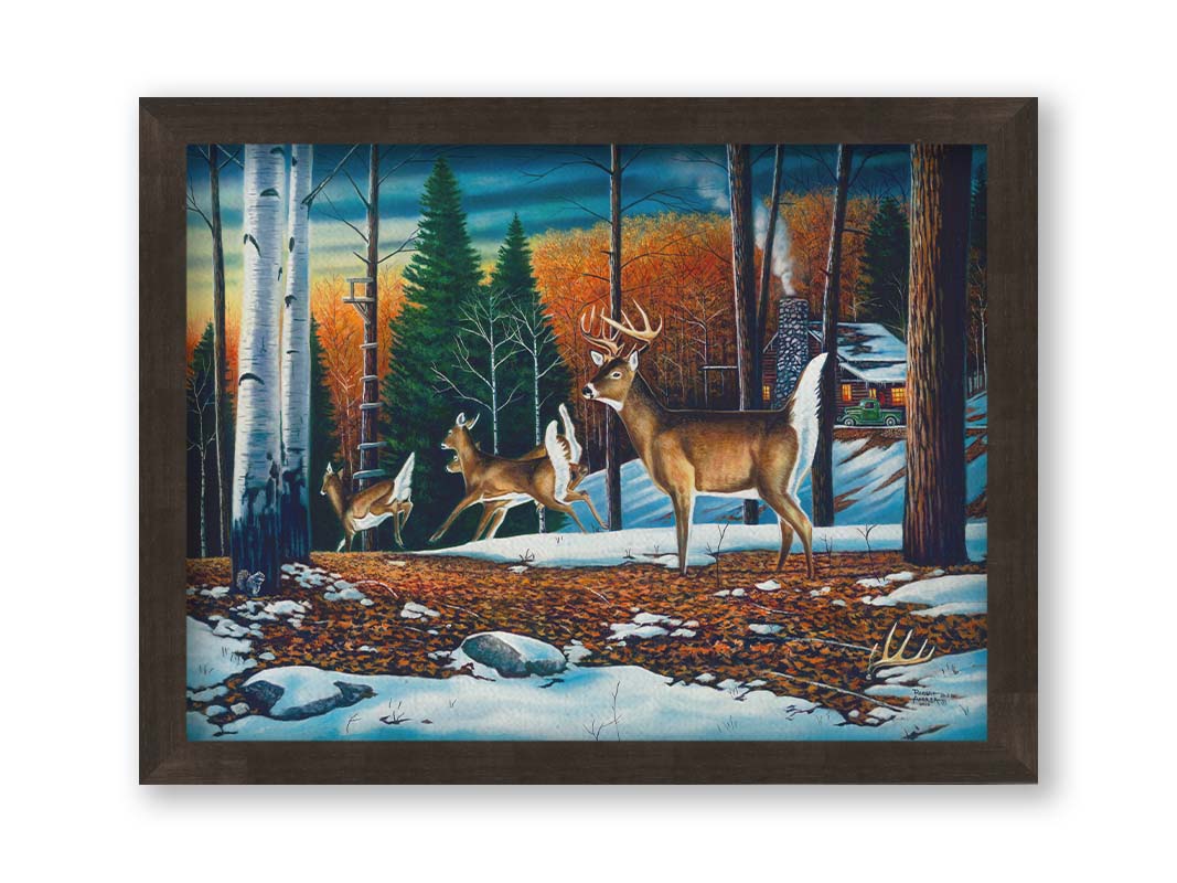 A painting of a group of deer running through the forest. There are snow and leaves on the ground, and a cabin in the distance. Printed on canvas and framed.