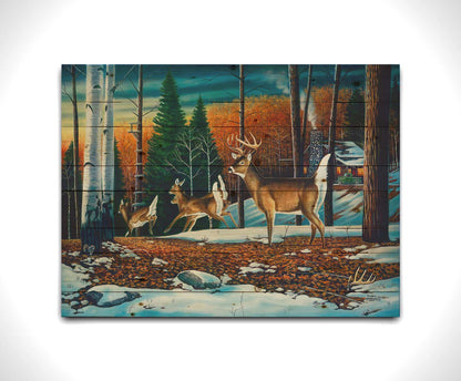 A painting of a group of deer running through the forest. There are snow and leaves on the ground, and a cabin in the distance. Printed on a wood pallet.