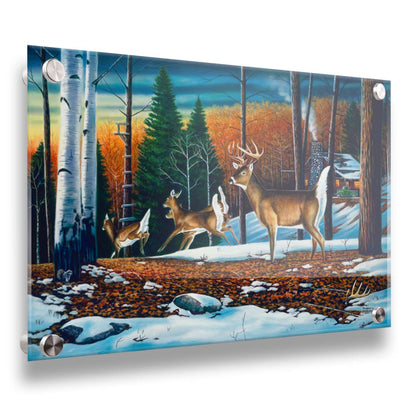 A painting of a group of deer running through the forest. There are snow and leaves on the ground, and a cabin in the distance. Printed on acrylic.