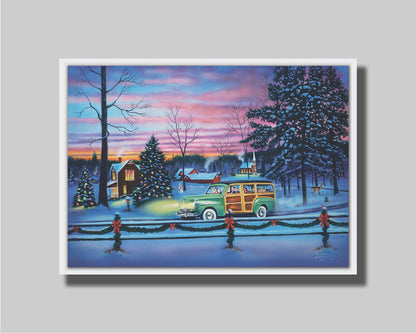 A painting of a snowy town, decorated with Christmas lights. A 1950s family drive past in a car full of presents at sunset. Printed on canvas in a float frame.