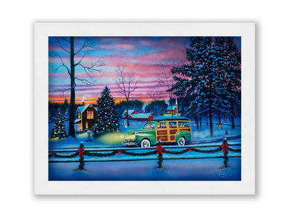 A painting of a snowy town, decorated with Christmas lights. A 1950s family drive past in a car full of presents at sunset. Printed on canvas and framed.