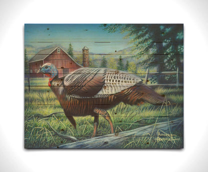 A painting of a turkey walking through the grass in front of a barn. Printed on a wood pallet.