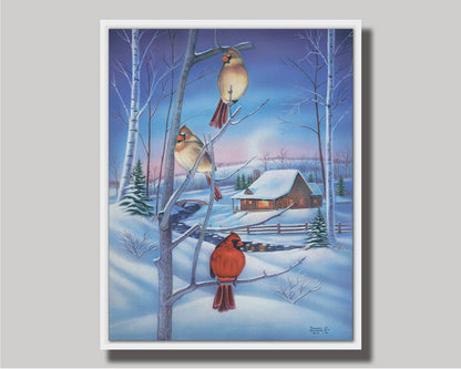 A painting of three cardinals, perched on branches above the snow. A cabin can be seen in the background, warm and inviting. Printed on canvas in a float frame.