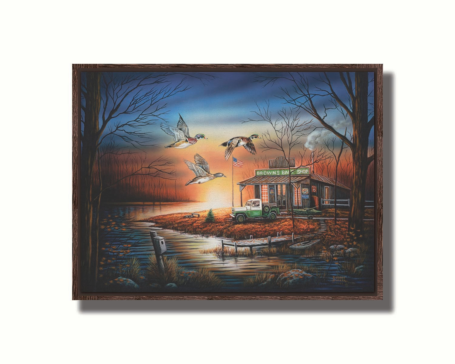 A painting of three ducks flying over the water, in front of a bait shop at sunset. Printed on canvas in a float frame.