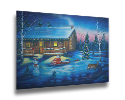 A painting of a snowy cabin decorated with Christmas lights. A deer treks through the snow in the yard, past a snowman to a stream. Printed on metal.