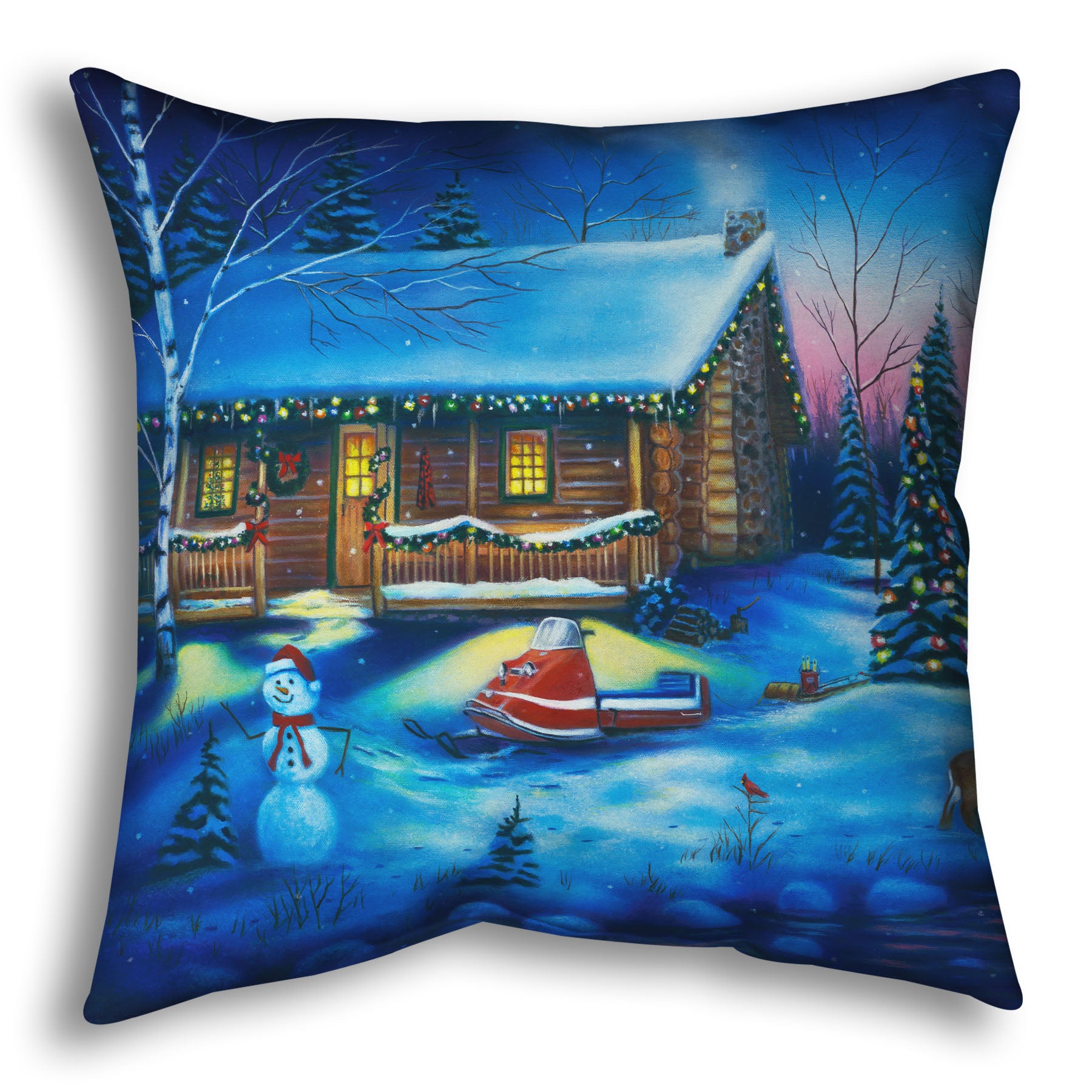 A festive throw pillow decorated with the painting of a snowy cabin decorated with Christmas lights.