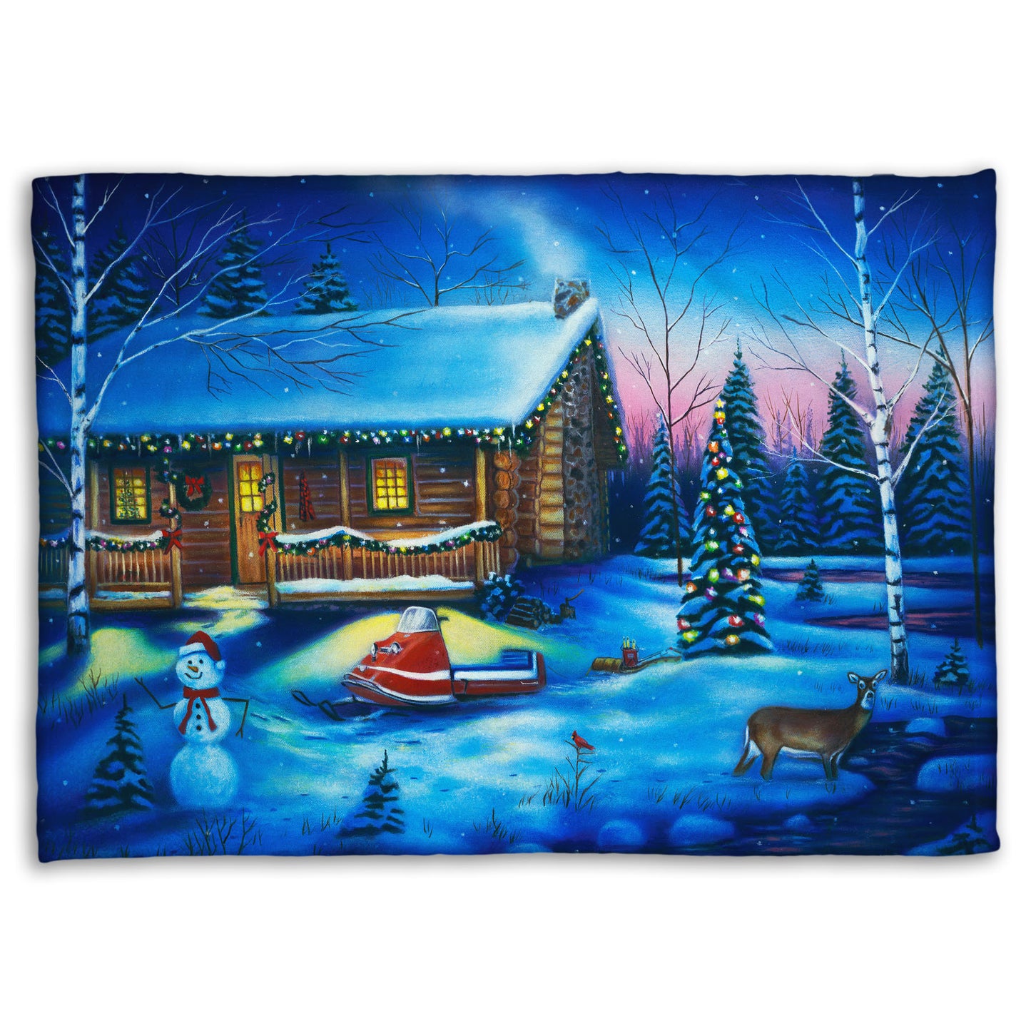 A festive coral fleece blanket decorated with the painting of a snowy cabin decorated with Christmas lights.