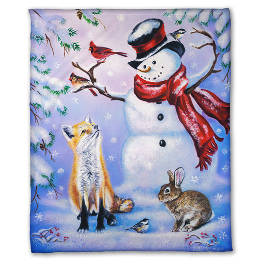 Coral fleece blanket with a winter scene of a snowman, fox, cardinals, and rabbit around a snowman.