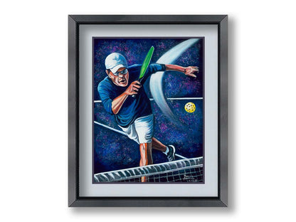 A painting of a man swinging a pickleball paddle, hitting the ball over the net. Printed on paper, matted, and framed.