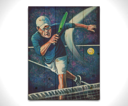 A painting of a man swinging a pickleball paddle, hitting the ball over the net. Printed on a wood pallet.