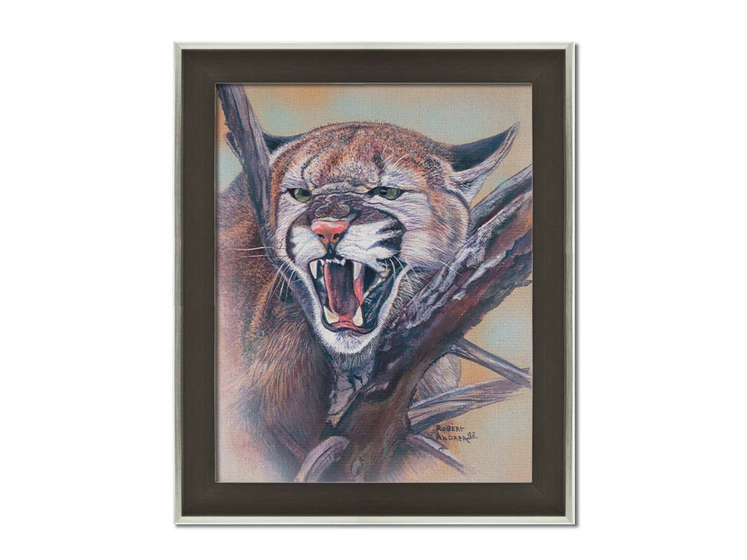 A painting of a snarling mountain lion peering through a tree. Printed on canvas and framed.