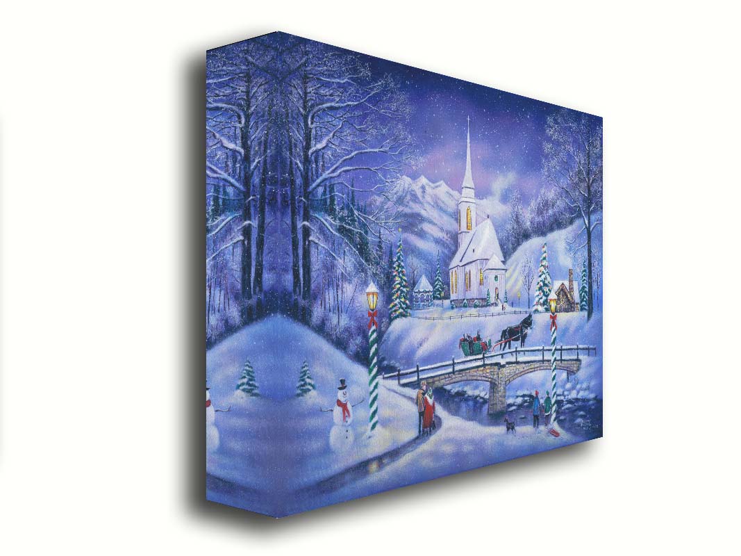 A painting of a snowy mountain town, decorated for Christmas. A tall church sits in the middle of town. A horse-drawn sleigh crosses a bridge over a freezing river. Printed on canvas.