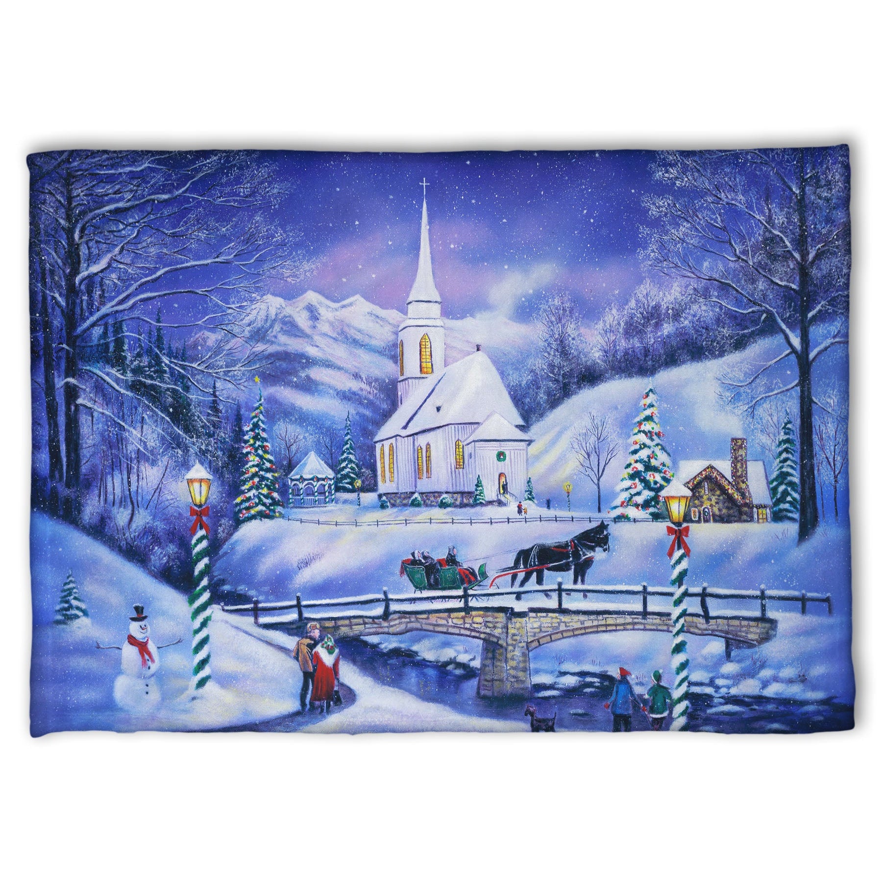 A coral fleece blanket designed with a snowy mountain town, decorated for Christmas. A tall church sits in the middle of town.