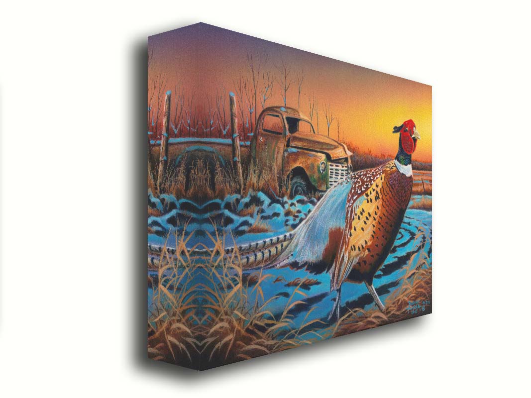 A painting of a pheasant trotting through a snowy field. In the background, an old green truck sits rusted. The sun is low in the sky, creating a soft orange atmosphere. Printed on canvas.