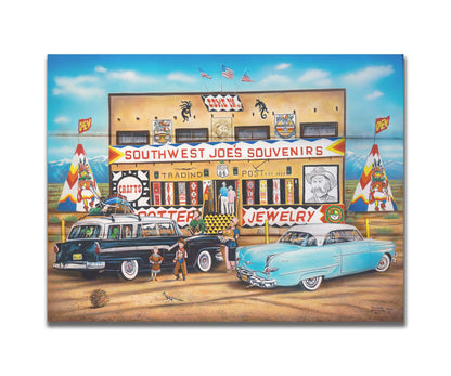 A painting of an American southwestern storefront. Several vintage cars packed for road trips are parked at the front of the souvenir shop. Printed on a box board.