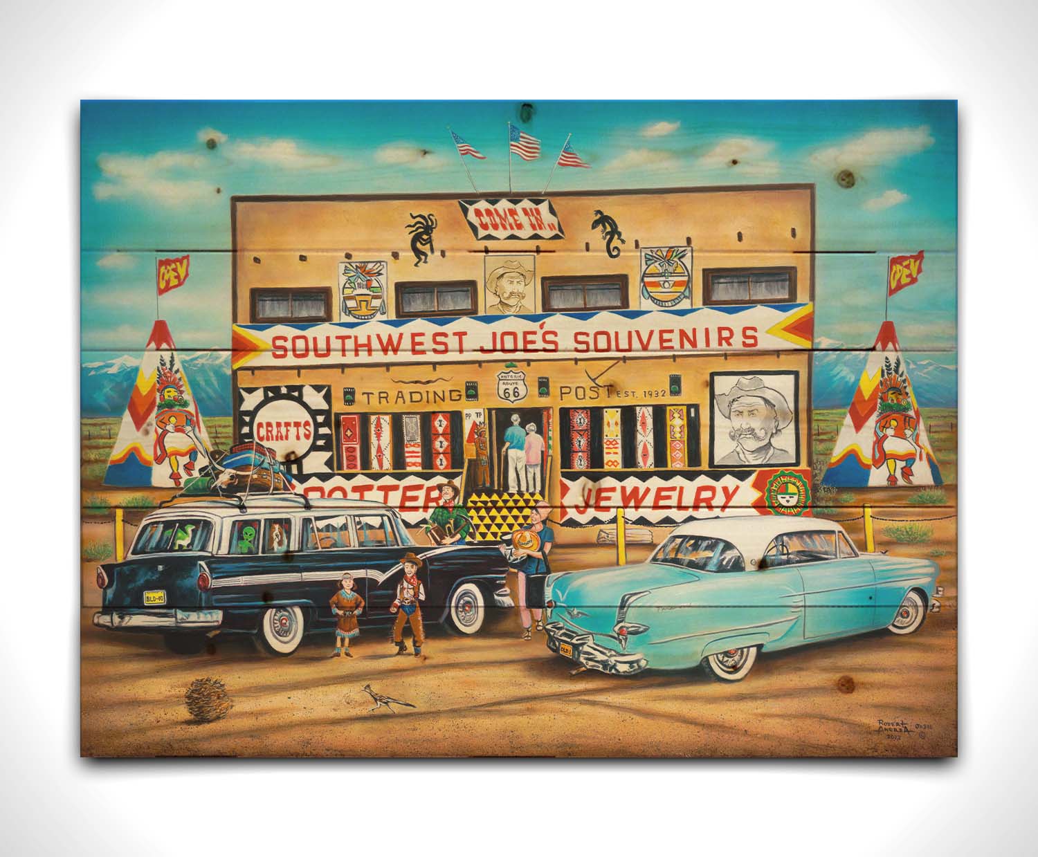 A painting of an American southwestern storefront. Several vintage cars packed for road trips are parked at the front of the souvenir shop. Printed on a wood pallet.