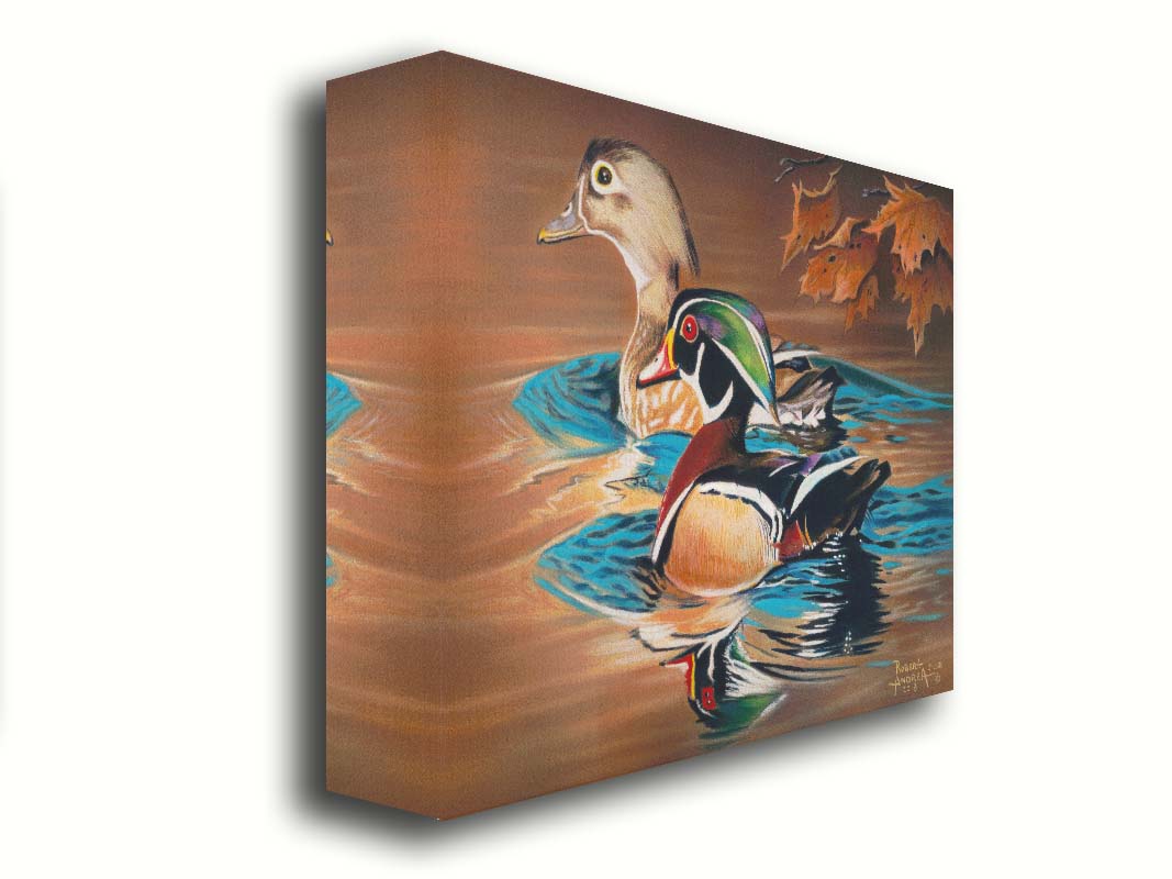 A painting of two wood ducks swimming through the water during fall. Their reflections are broken by the ripples of the water. Printed on canvas.