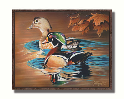 A painting of two wood ducks swimming through the water during fall. Their reflections are broken by the ripples of the water. Printed on canvas in a float frame.