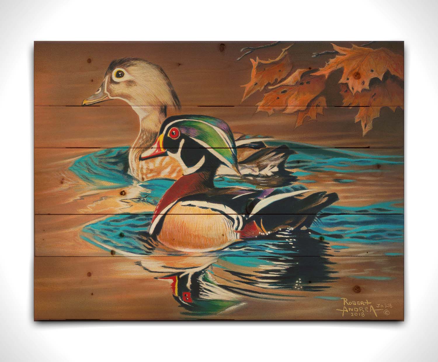 A painting of two wood ducks swimming through the water during fall. Their reflections are broken by the ripples of the water. Printed on a wood pallet.