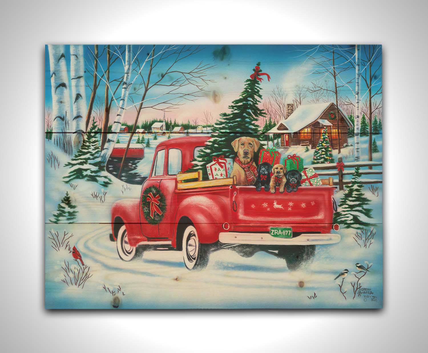 A painting of a little red pickup truck, carrying presents, a Christmas tree, and a family of puppies. It is drivng down a snowy path toward a cozy, inviting log cabin in the distance. Printed on a wood pallet.