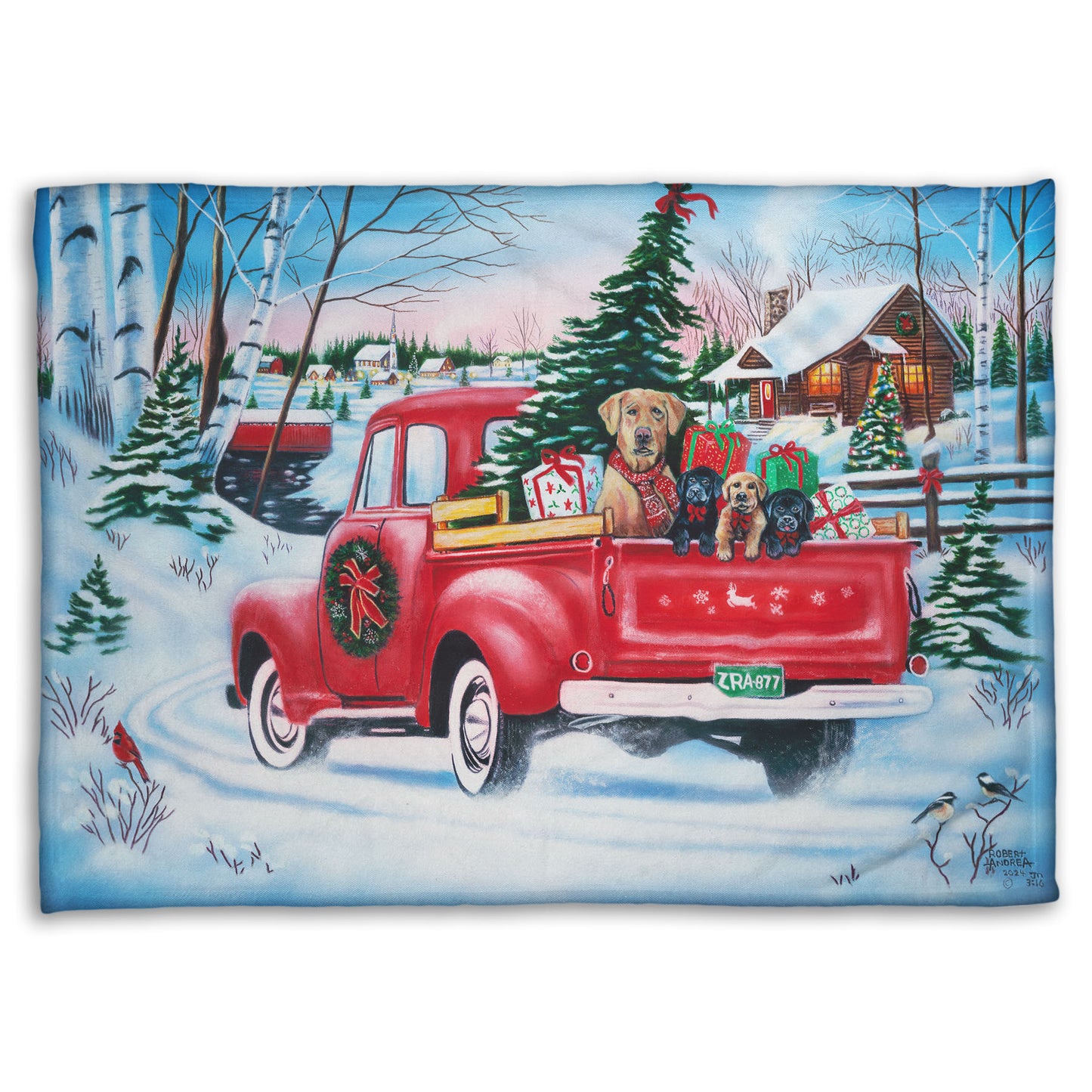 Festive blanket with a red truck carrying a Christmas tree, puppies, and presents in a snowy village scene.