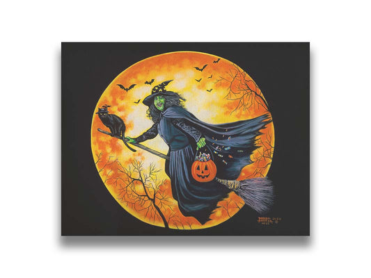 A painting of a witch, flying on a broom in front of an orange moon while carrying a pumpkin-shaped basket of candy. Printed on canvas.