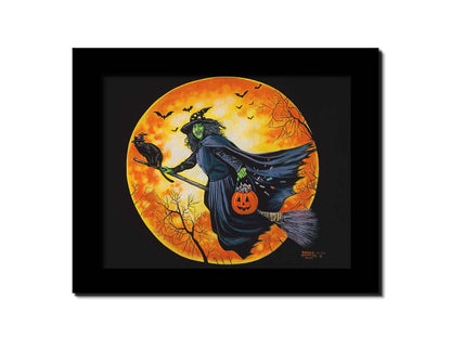 A painting of a witch, flying on a broom in front of an orange moon while carrying a pumpkin-shaped basket of candy. Printed on canvas and framed.