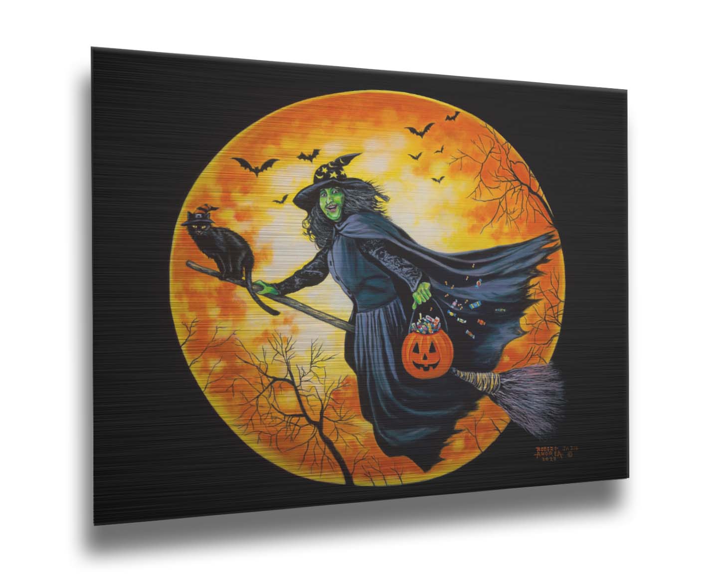 A painting of a witch, flying on a broom in front of an orange moon while carrying a pumpkin-shaped basket of candy. Printed on metal.