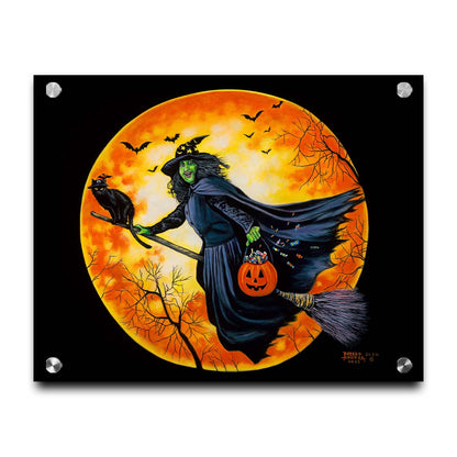 A painting of a witch, flying on a broom in front of an orange moon while carrying a pumpkin-shaped basket of candy. Printed on acrylic.