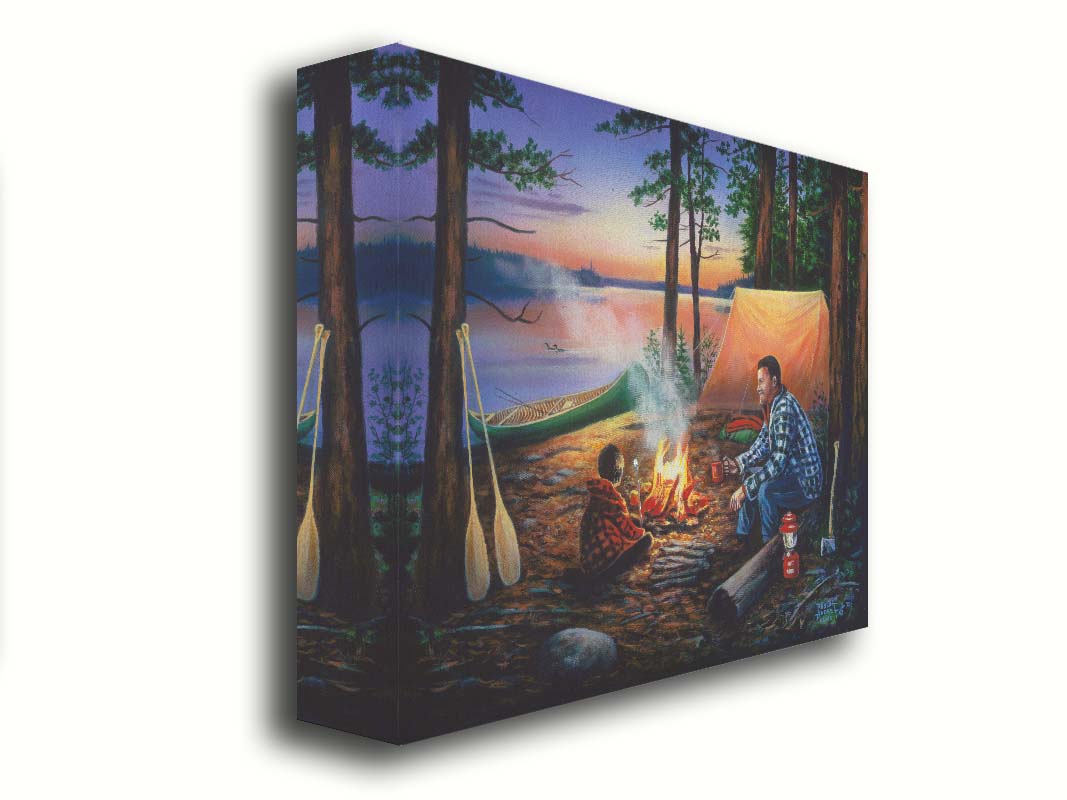 A painting of a father and son camping in the woods. The sun sets in the background over a lake, as the two sit at a campfire roasting marshmallows. Printed on canvas.