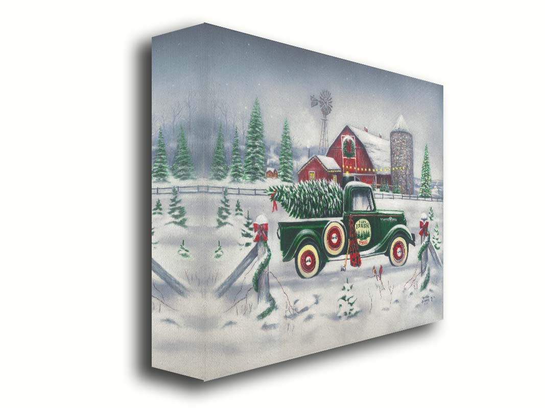 A painting of a green truck on a snowy road, preparing to deliver a freshly cut evergreen tree to a customer. A big red barn sits in the background, surrounded by large evergreens decorated for Christmas. Printed on canvas.