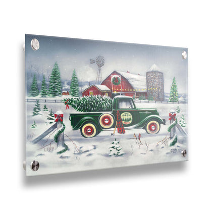 A painting of a green truck on a snowy road, preparing to deliver a freshly cut evergreen tree to a customer. A big red barn sits in the background, surrounded by large evergreens decorated for Christmas. Printed on acrylic.