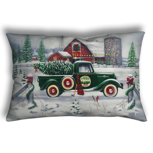 Decorative pillow with a vintage truck and Christmas tree design.
