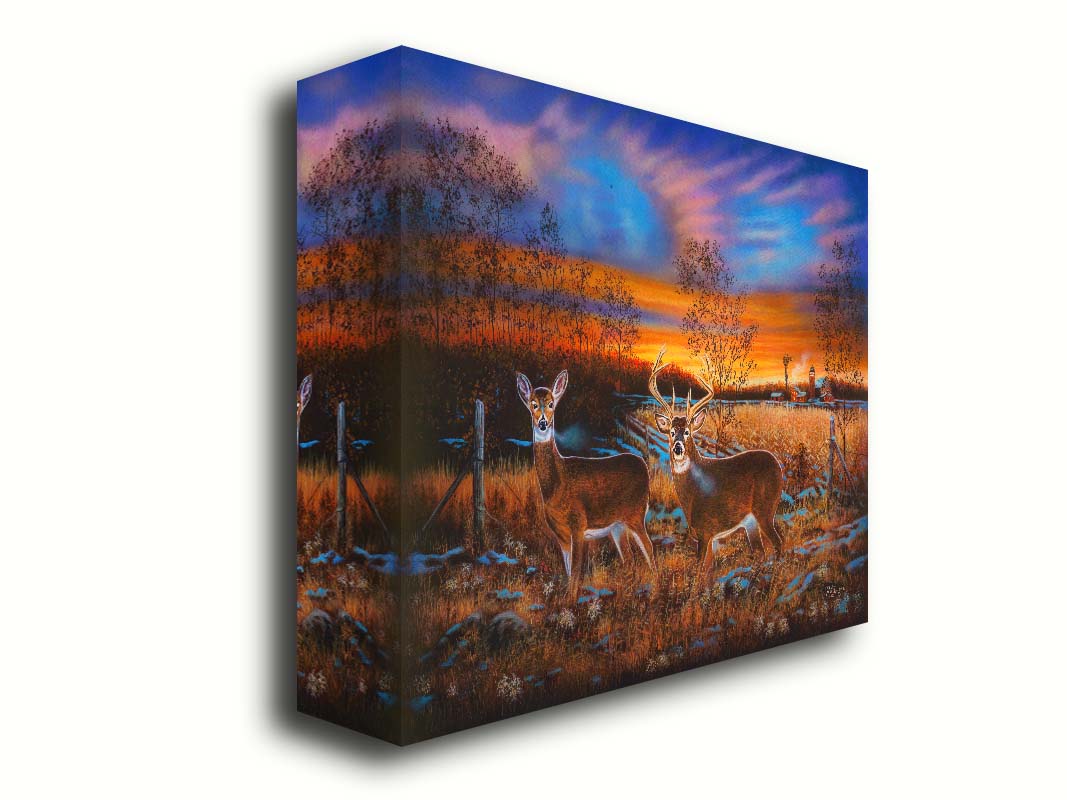 A painting of two whitetail deer in a field during a vivid sunset, with a large barn in the background. Printed on canvas.