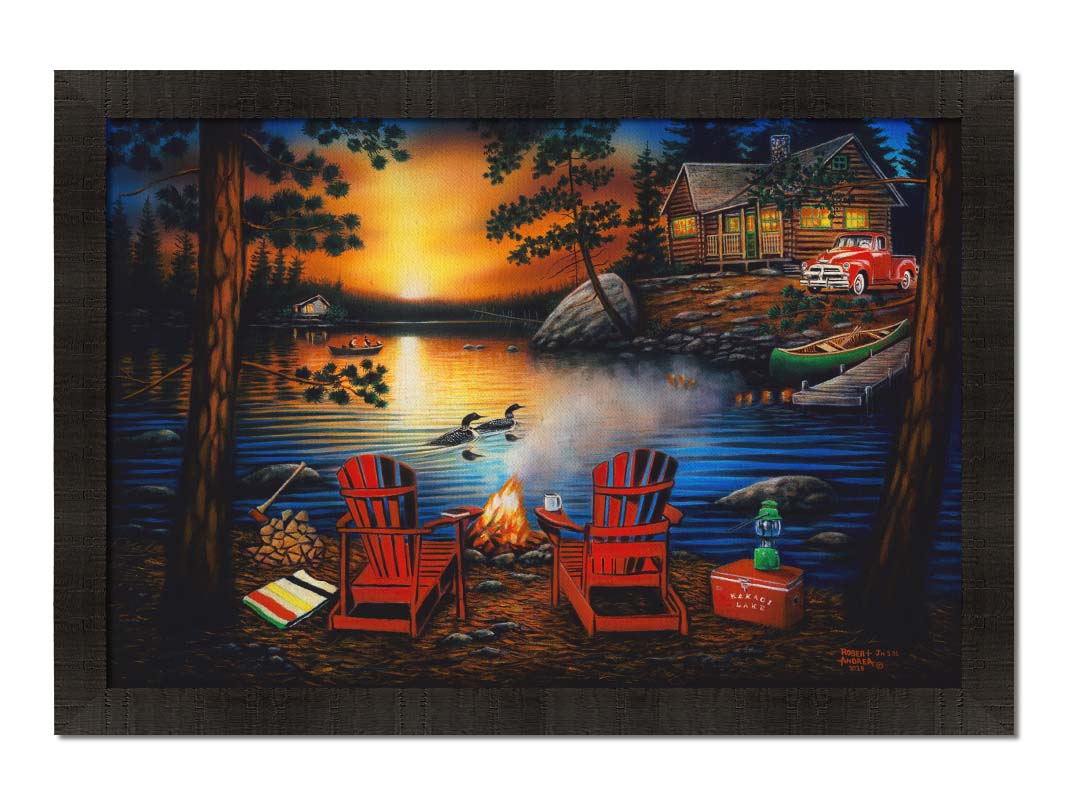 A painting of Kakagi Lake in Ontario, Canada. Cabins sit on the shore by docks of canoes used by fishermen. In the foreground, lawn chairs sit by a campfire. Printed on canvas and framed.