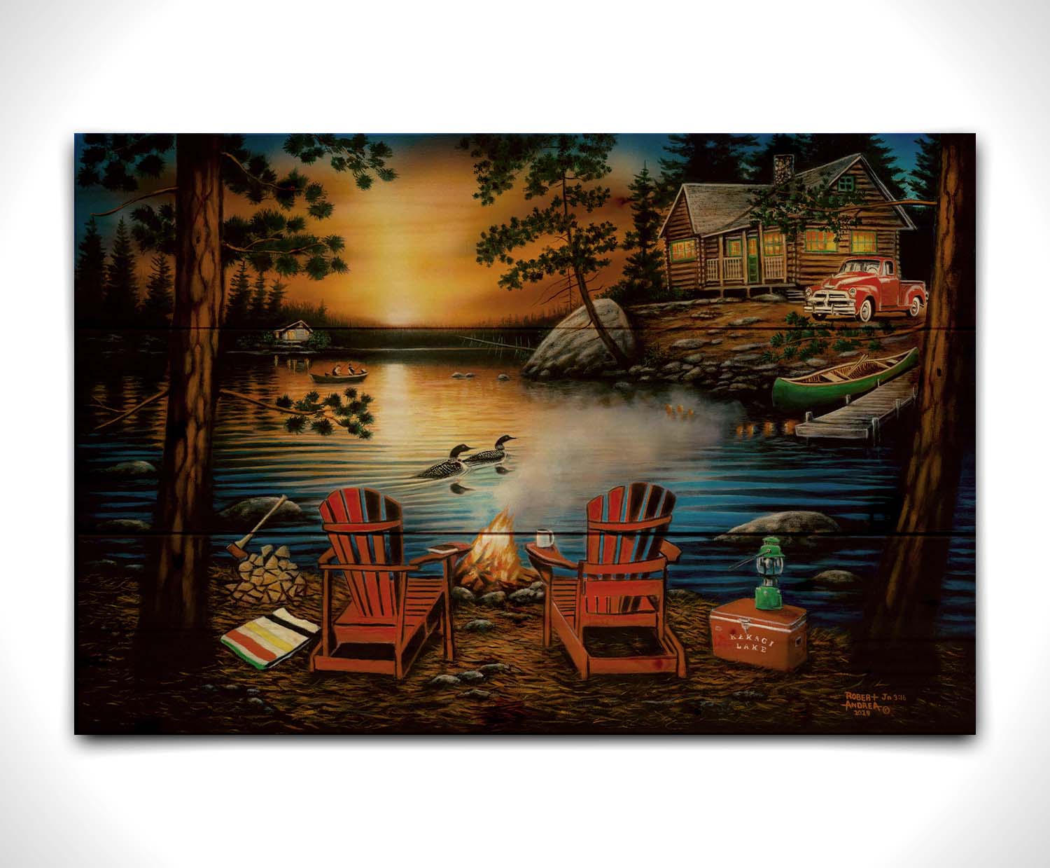 A painting of Kakagi Lake in Ontario, Canada. Cabins sit on the shore by docks of canoes used by fishermen. In the foreground, lawn chairs sit by a campfire. Printed on a wood pallet.