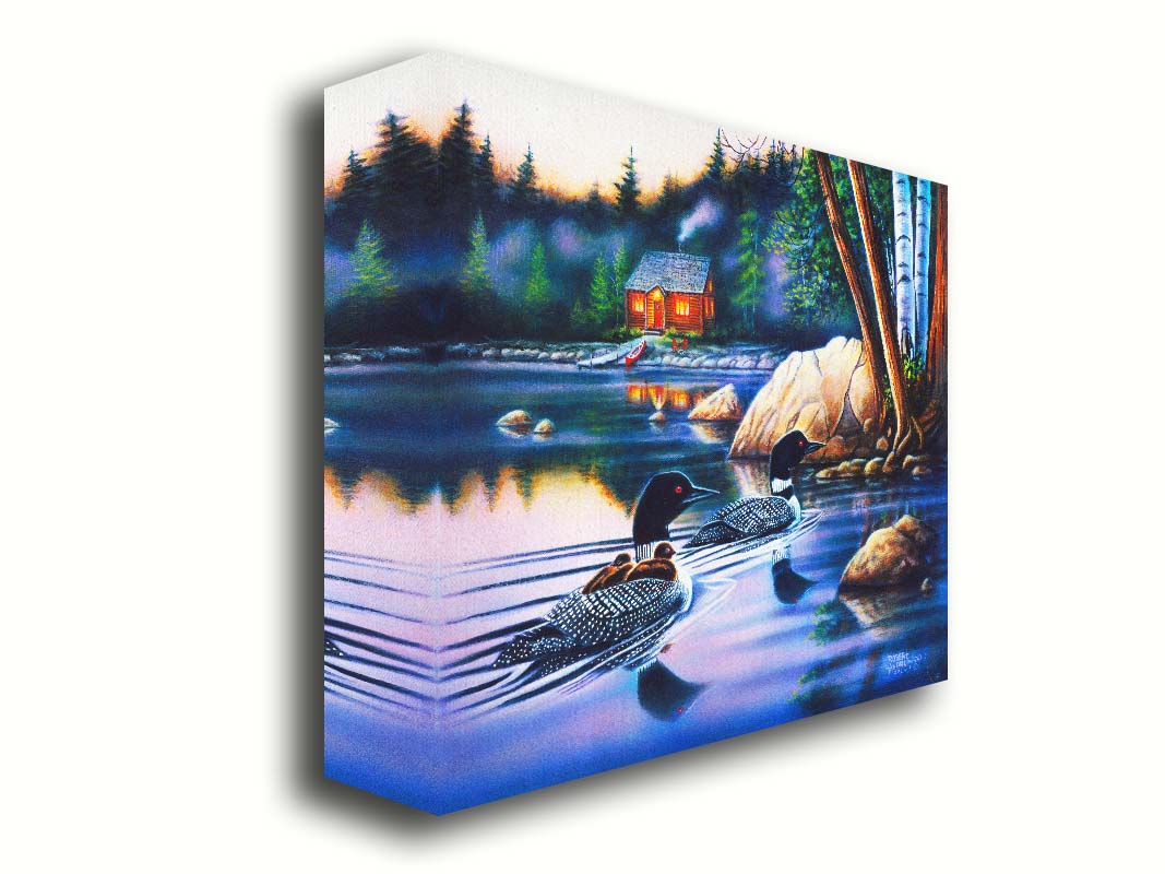 A painting of a family of loons swimming on a lake carrying their young. A pier extends to a cabin in the woods in the background. Printed on canvas.