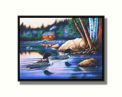 A painting of a family of loons swimming on a lake carrying their young. A pier extends to a cabin in the woods in the background. Printed on canvas in a float frame.