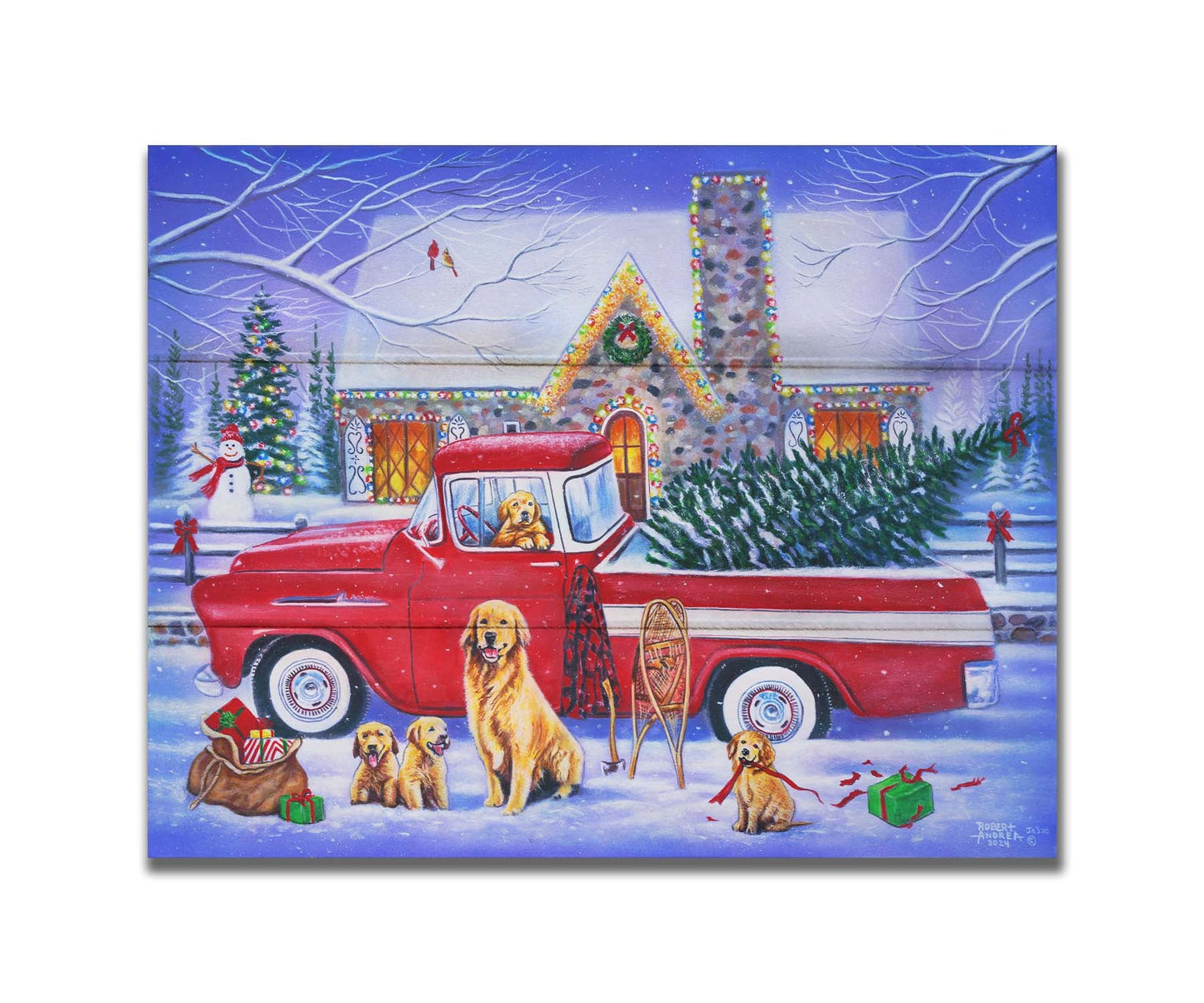 A painting of a red truck, parked in the snow outside a stone house decorated with Christmas lights. An evergreen is in the bed of the truck, and a family of golden retrievers sit in and around the vehicle. Printed on a box board.