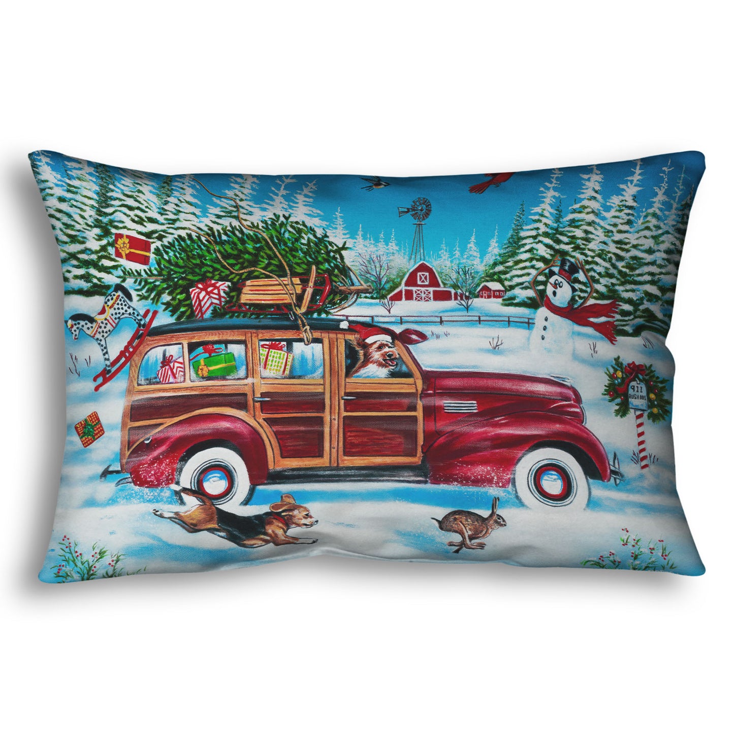 A throw pillow printed with a festive Christmas painting, with a classic wood panel car speeding by with presents.