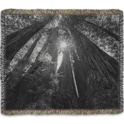 Woven throw blanket designed with a black and white photo looking up at the giant redwood trees in Redwood National Park, California.